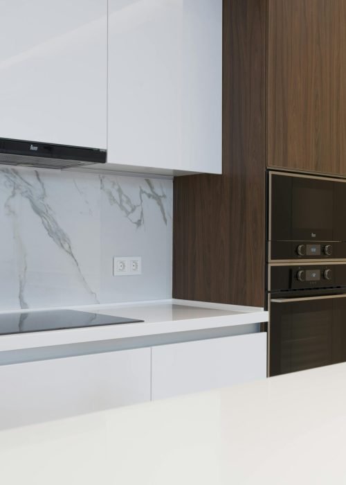 Contemporary clean kitchen with sleek appliances and wooden cabinetry, perfect for a new home.