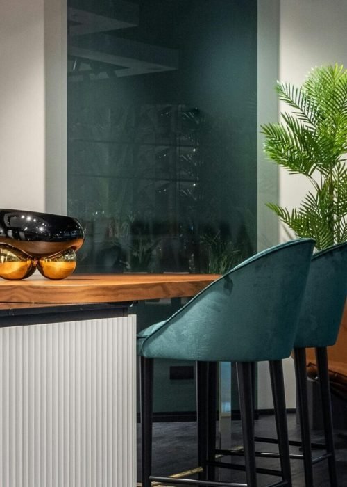 Elegant modern kitchen with sleek bar stools and contemporary decor.